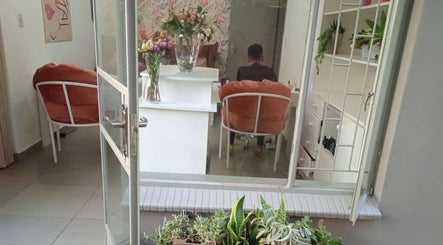 Inviting seating and floral decor at O'riain Beauty, Pretoria, Gauteng, ZA showcasing elegance and comfort.