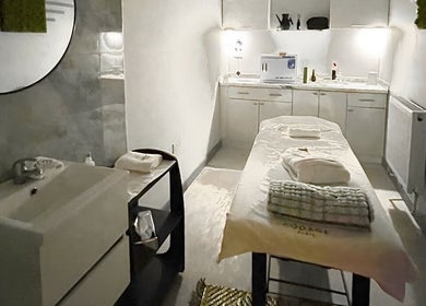 Calm treatment room at Belle Vous Spa Nine Elms, London, England, GB with plush massage table and warm lighting.