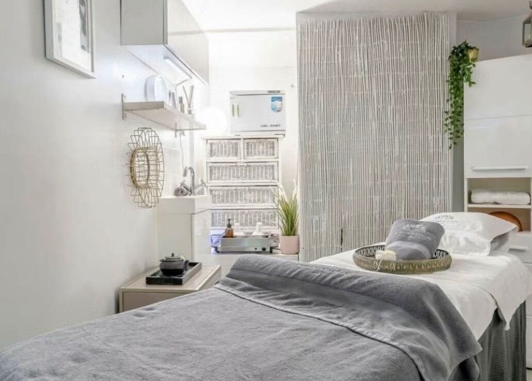 Tranquil treatment room at Wellness Skin & Laser Centre, London, England, GB with soft lighting and cozy bed.