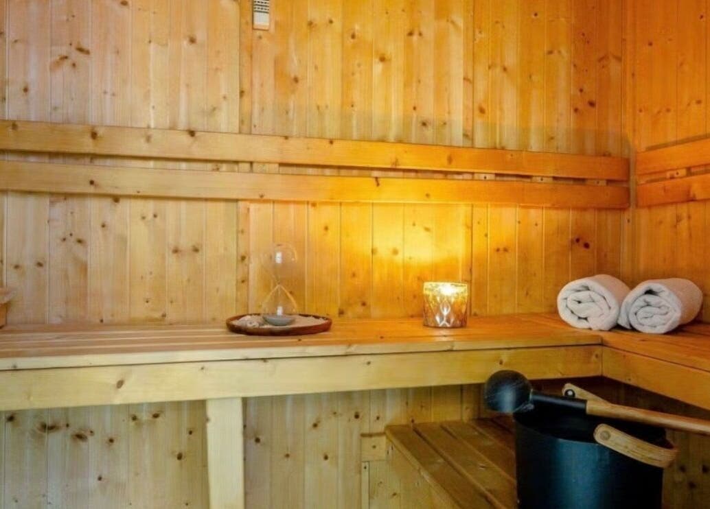 Tranquil sauna at Wellness Skin & Laser Centre in London, England, GB with warm lighting and towels.