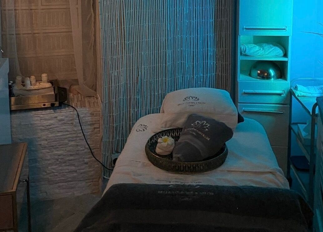 Relaxing spa room at Wellness Skin & Laser Centre in London, England, GB with a cozy treatment bed and ambient lighting.