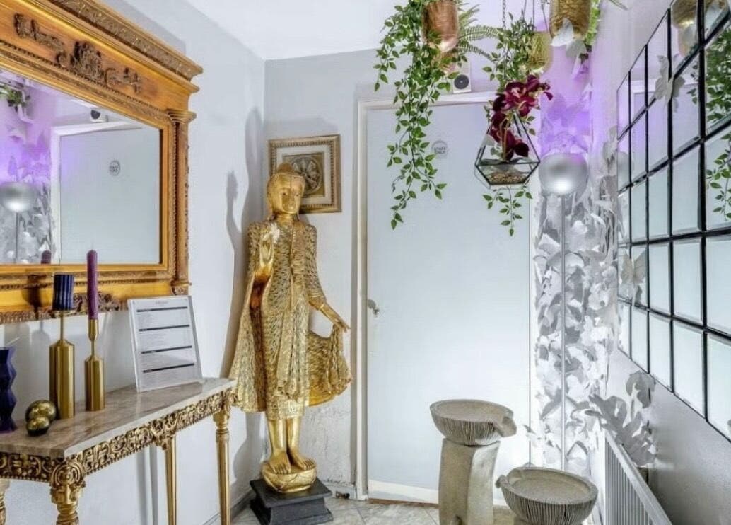 Elegant decor at Wellness Skin & Laser Centre, London, England, GB. Ornate mirror and golden statue create a serene ambiance.