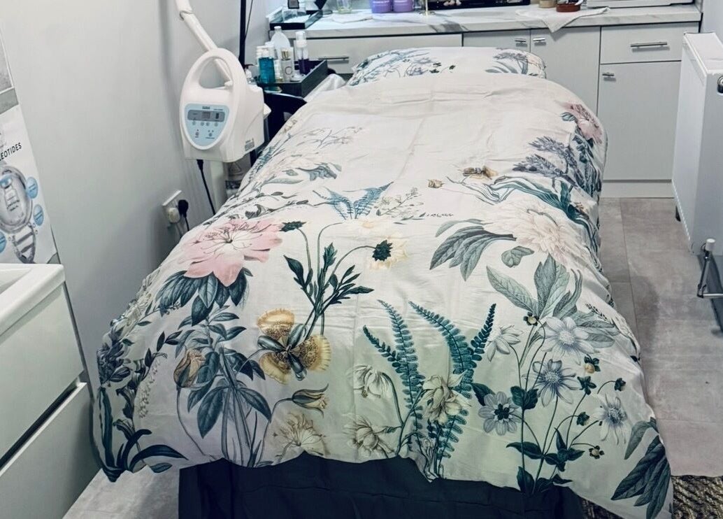 Treatment room at Belle Vous Spa Nine Elms, London, England, GB with floral bedding and modern equipment.