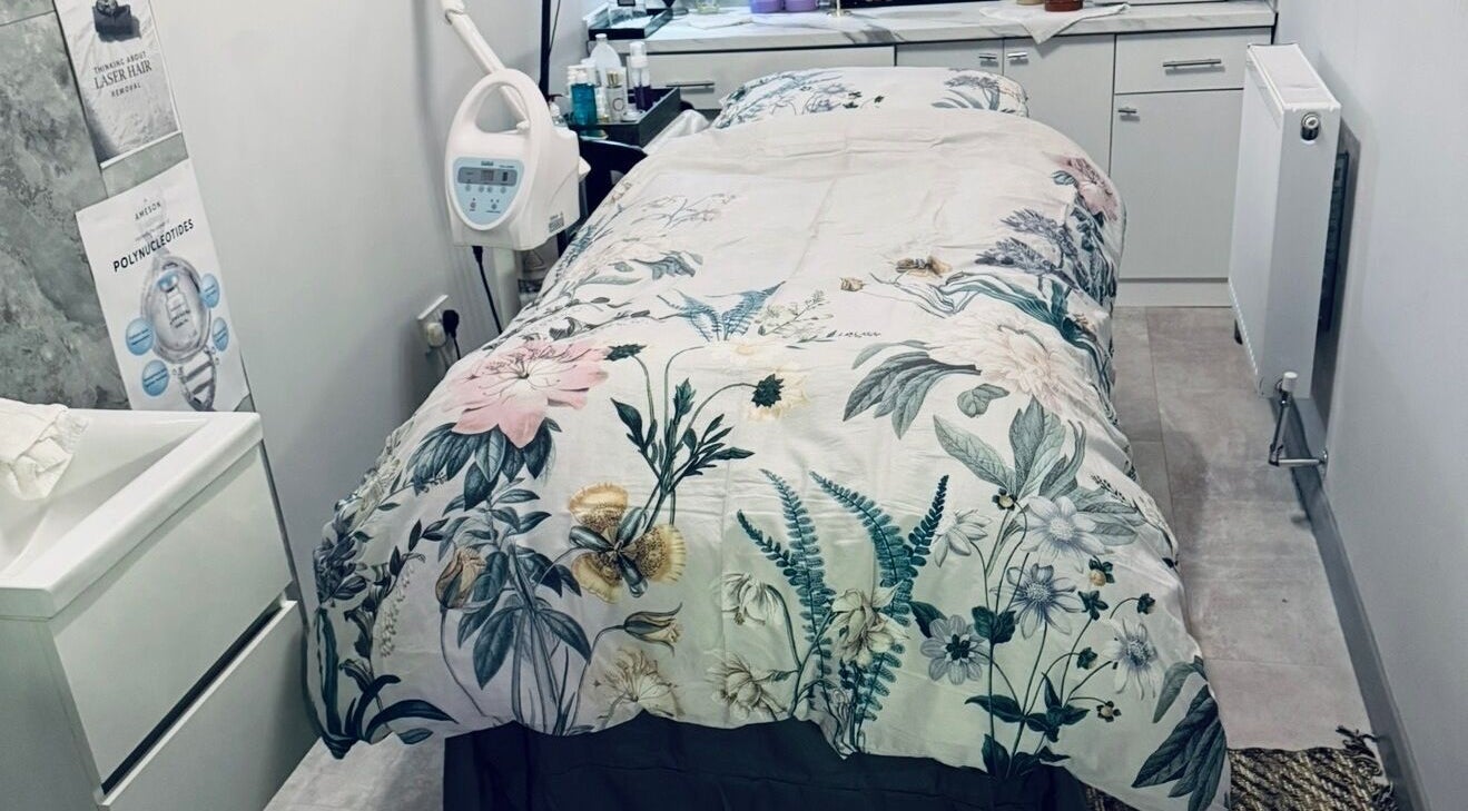 Treatment room at Belle Vous Spa Nine Elms, London, England, GB with floral bedding and modern equipment.