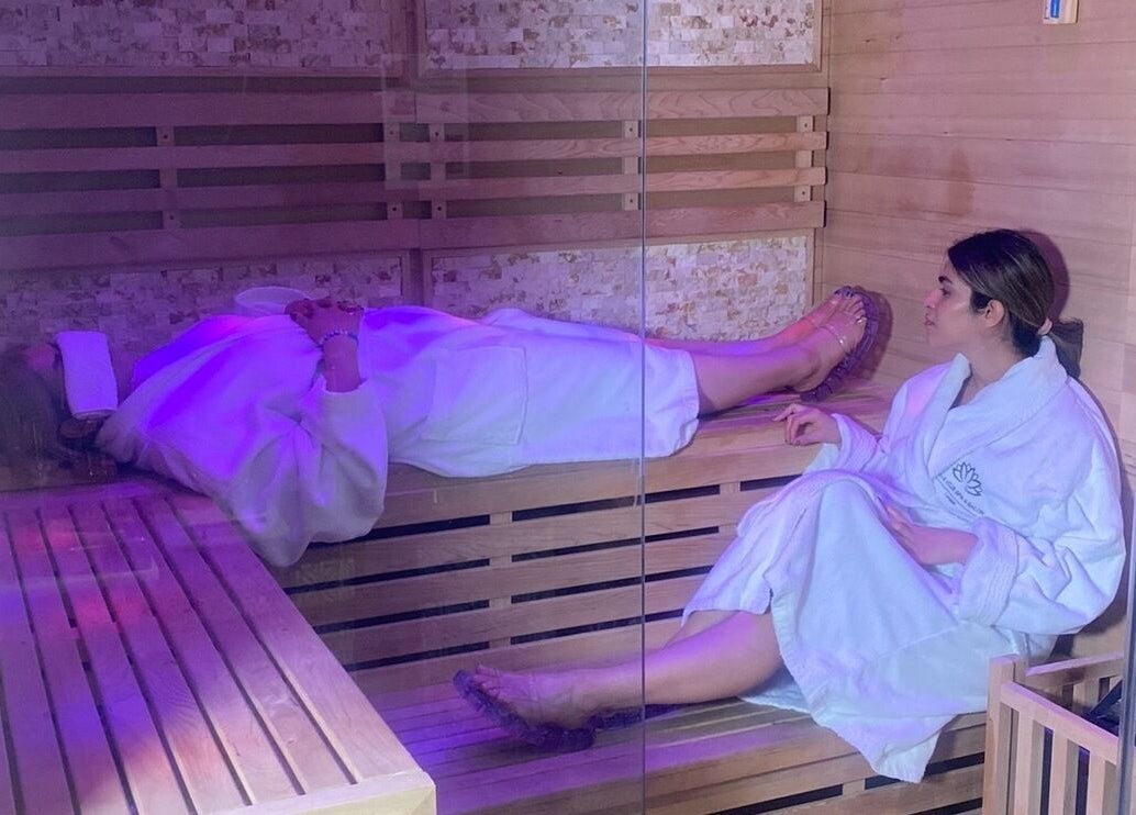 Relaxing sauna experience at Belle Vous Spa Nine Elms, London, England, GB with guests in white robes enjoying.