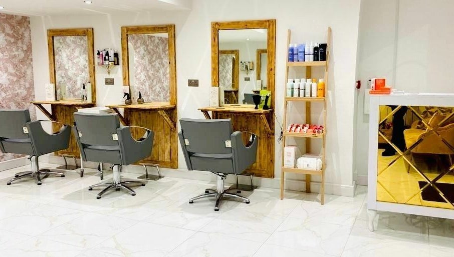 Modern salon interior at Jade Slater Hair Design in York, England, GB featuring stylish chairs and elegant decor.
