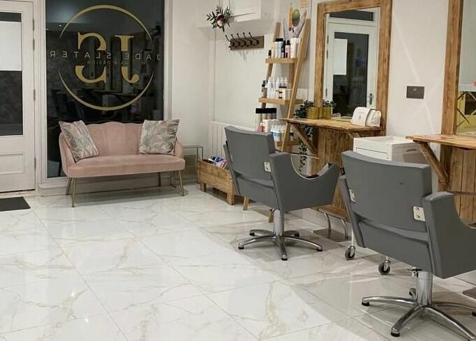 Elegant interior of Jade Slater Hair Design in York, England, GB, featuring modern chairs and a cozy waiting area.
