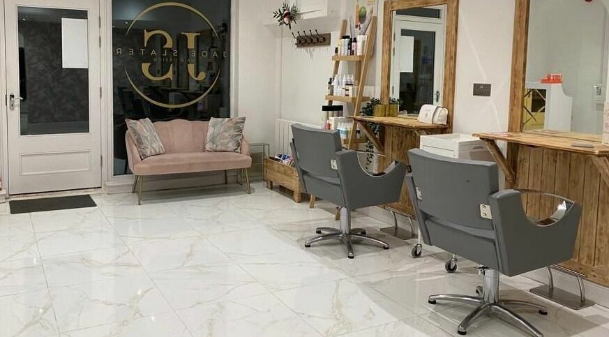 Elegant interior of Jade Slater Hair Design in York, England, GB, featuring modern chairs and a cozy waiting area.