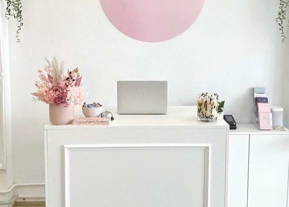 Reception desk at The Gloss Studio with floral decor in Lower Plenty, VIC, AU.