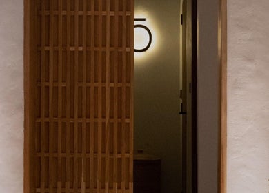 Elegant wooden door at Koya Spa Seminyak, Bali, Bali, ID inviting tranquility and relaxation.