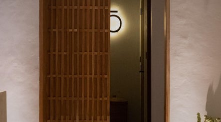 Elegant wooden door at Koya Spa Seminyak, Bali, Bali, ID inviting tranquility and relaxation.