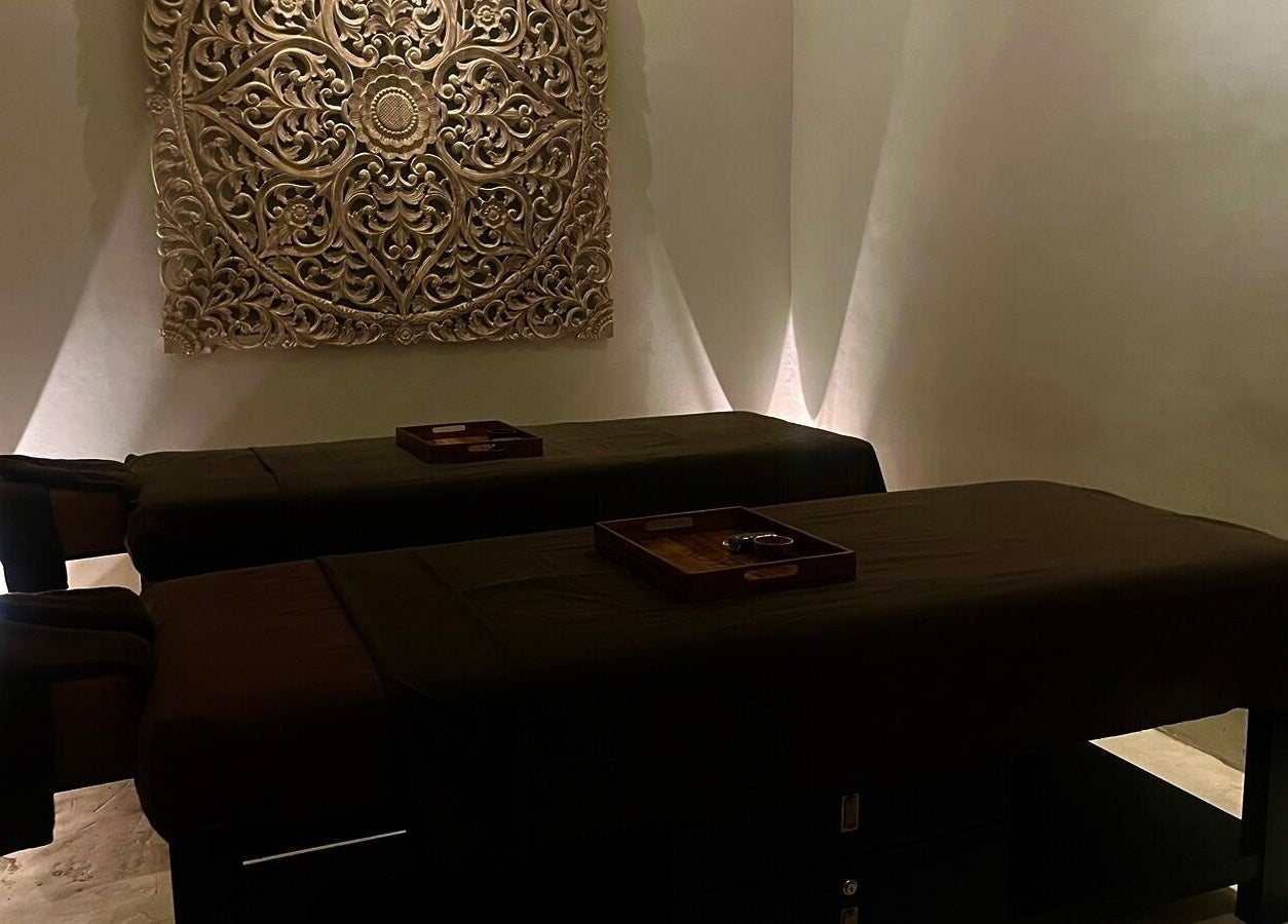 Tranquil massage room at Koya Spa, Bali, Bali, ID with ambient lighting and intricate wall art.