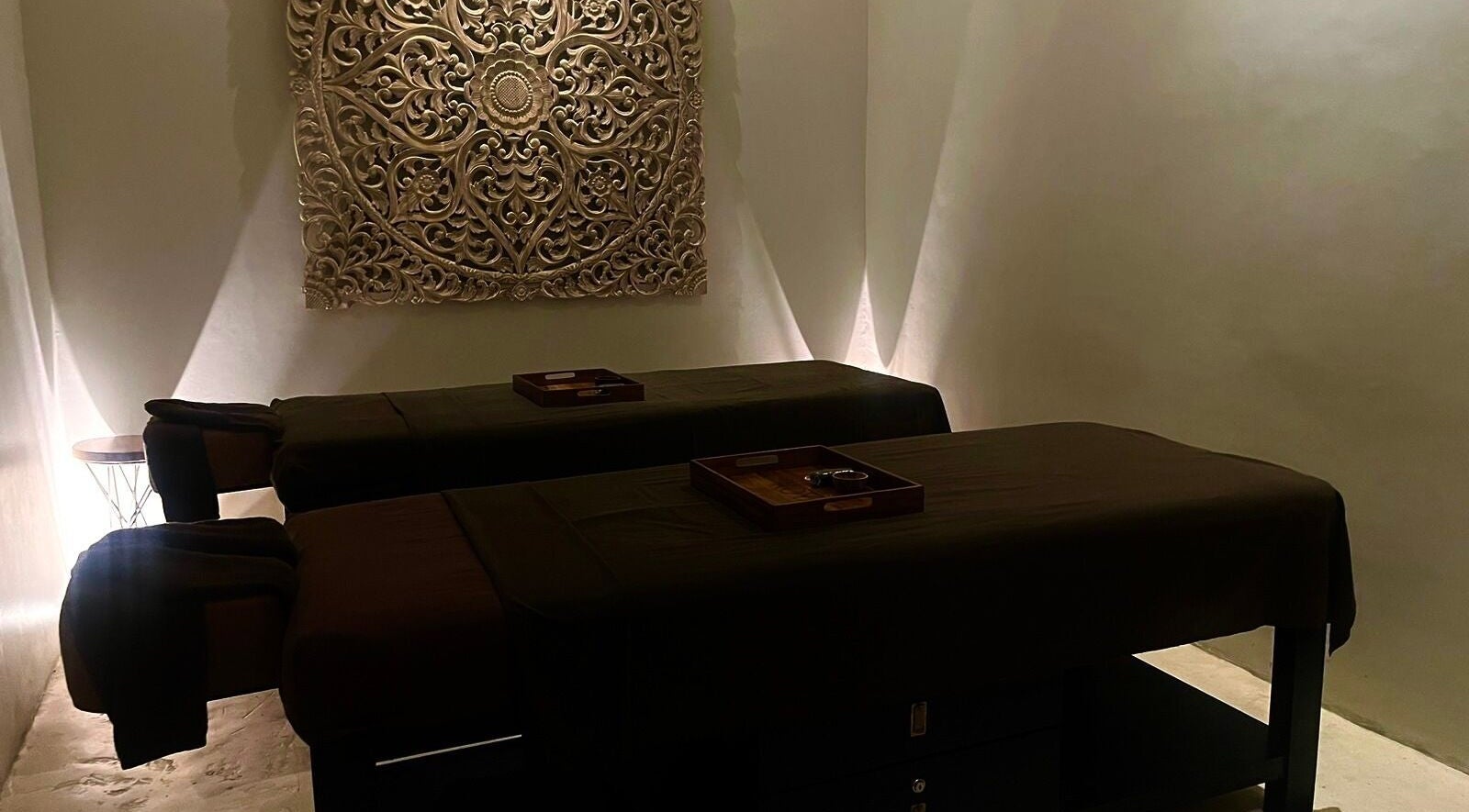 Tranquil massage room at Koya Spa, Bali, Bali, ID with ambient lighting and intricate wall art.