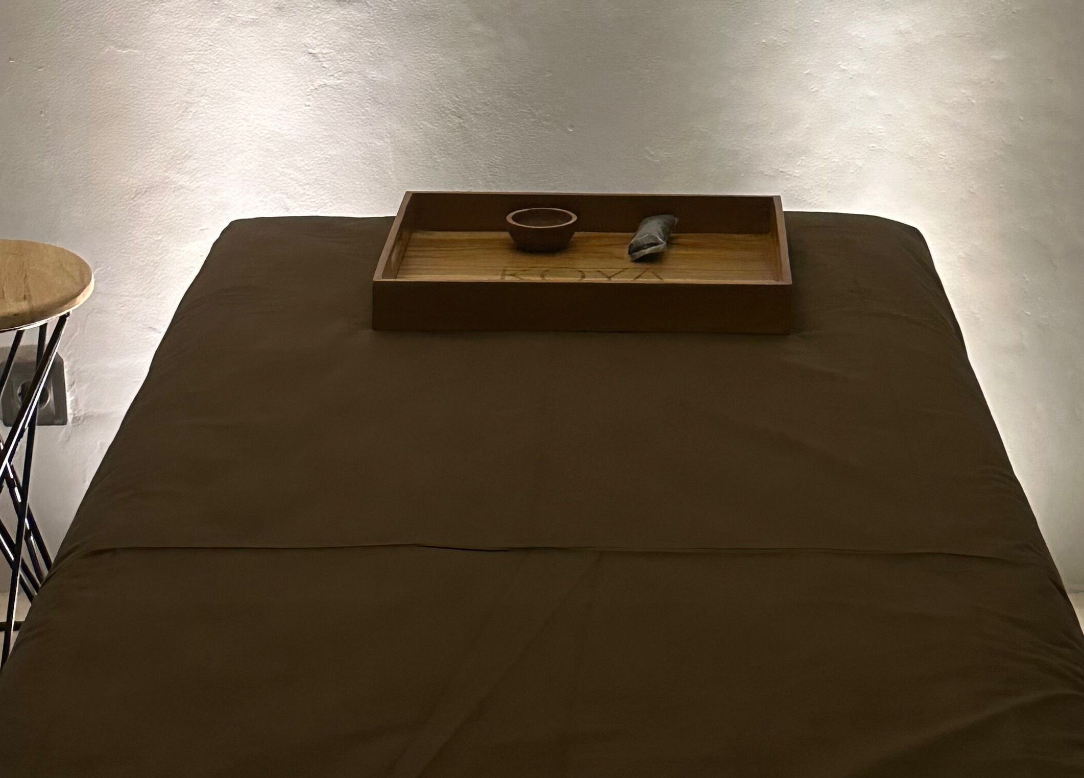 Relaxing massage table at Koya Spa, Bali, Bali, ID set with a wooden tray for tranquility.