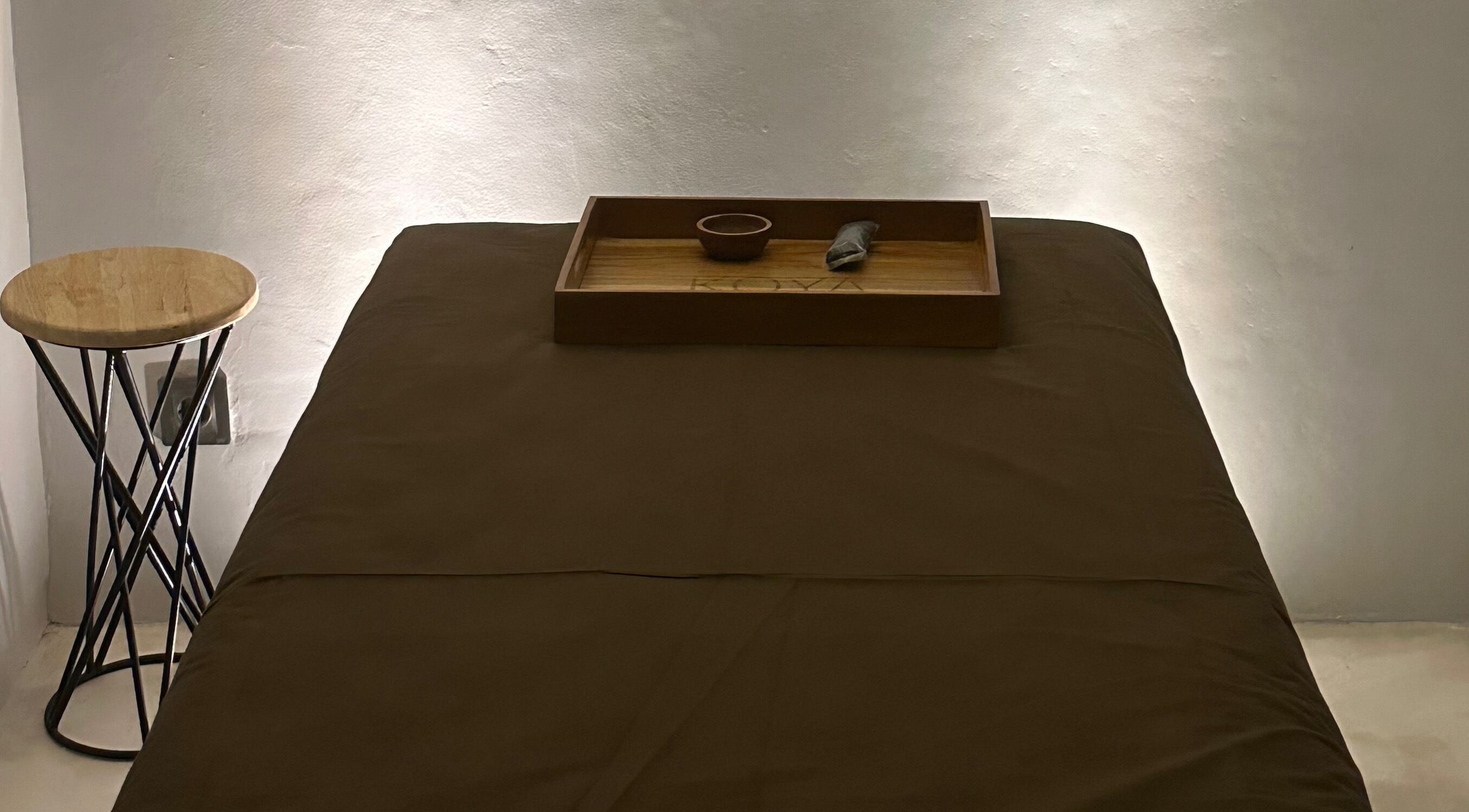 Relaxing massage table at Koya Spa, Bali, Bali, ID set with a wooden tray for tranquility.