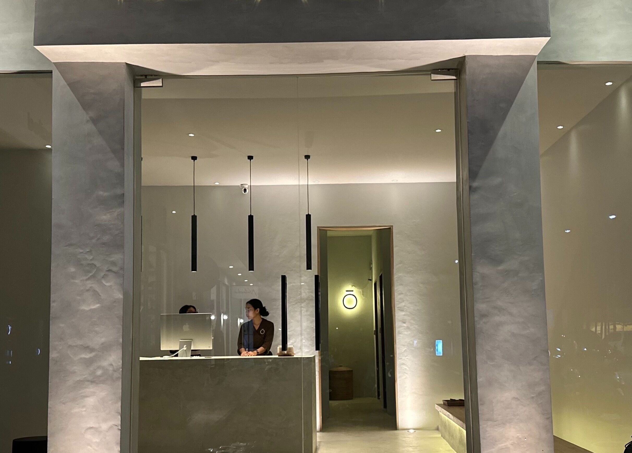 Elegant entrance of Koya Spa in Bali, Bali, ID, featuring a modern reception desk and ambient lighting.