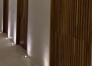 Elegant wooden hallway with ambient lights at Koya Spa, Bali, Bali, ID.