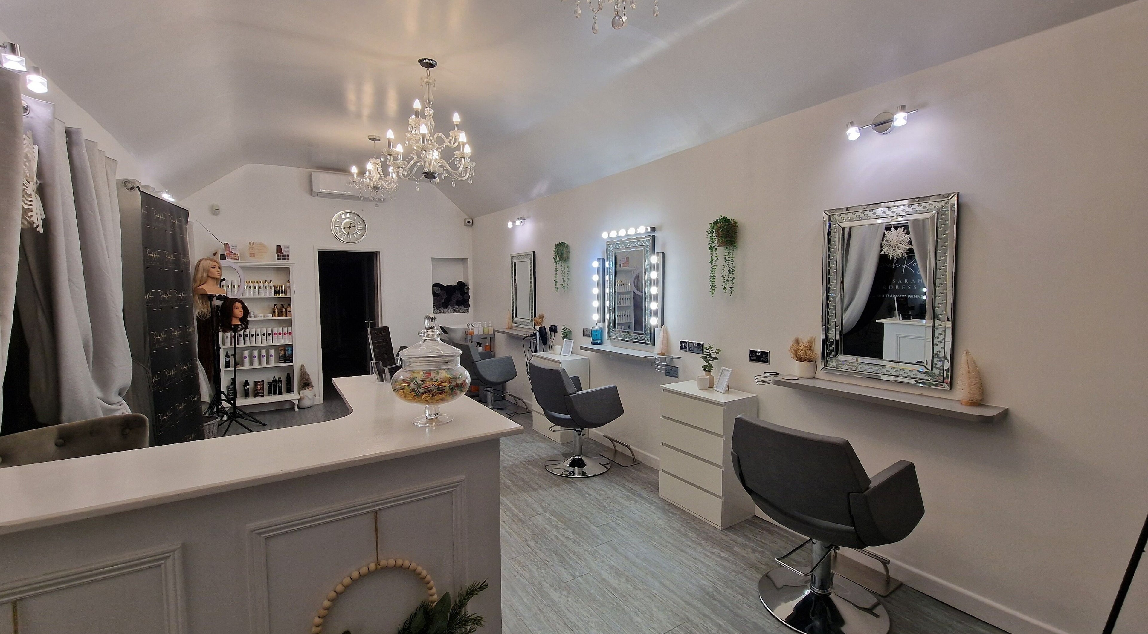 Elegant salon interior at By Sarah Hairdressing, March, England, GB, featuring stylish mirrors and hairdressing chairs.