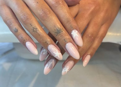 Styled nails at Annabelle’s Beauty, Camberley, England, GB featuring soft pink shades with star designs.