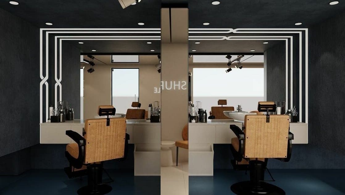 Interior of Shuffle Gents Barber in Mubarak Al-kabeer Governorate, featuring sleek chairs and modern decor.