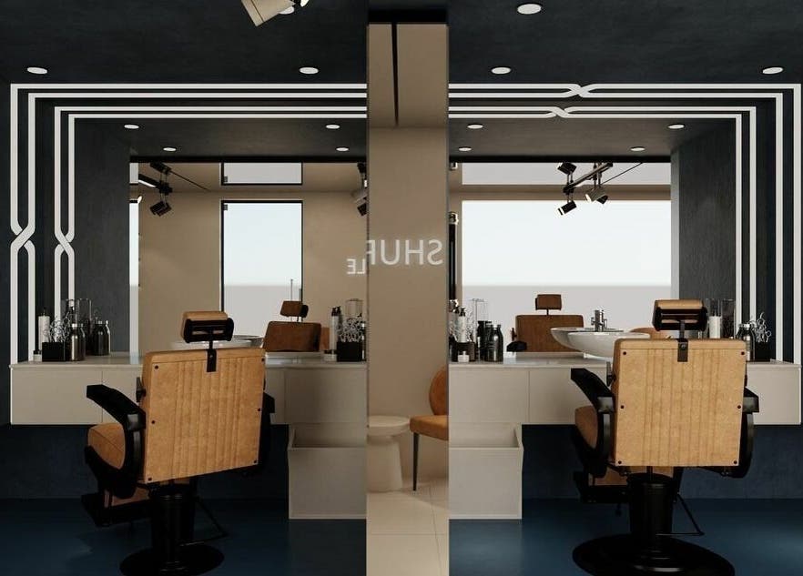 Interior of Shuffle Gents Barber in Mubarak Al-kabeer Governorate, featuring sleek chairs and modern decor.