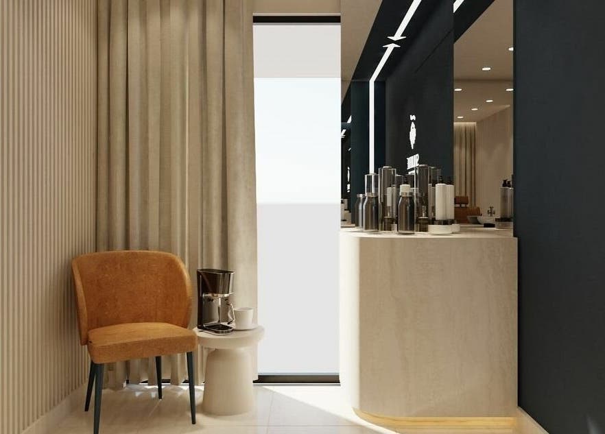 Cozy waiting area at Shuffle Gents Barber in Mubarak Al-kabeer Governorate, KW with a stylish chair and table.