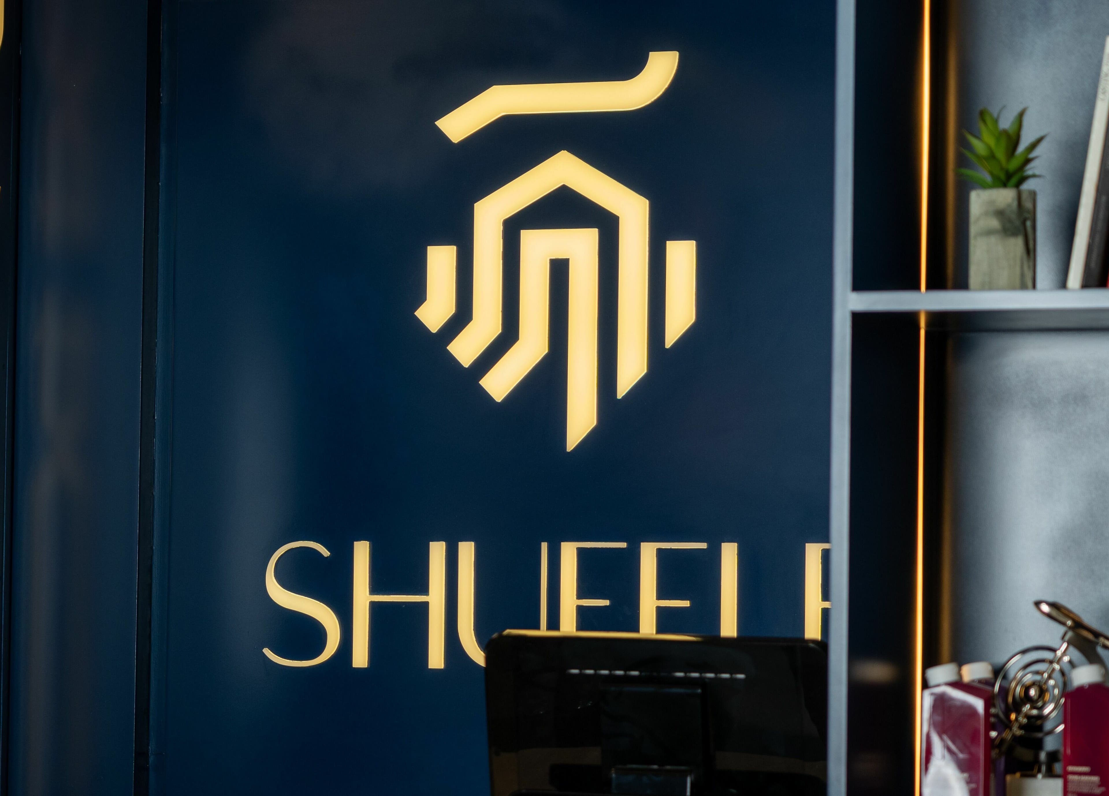 Logo display at Shuffle Gents Barber, Mubarak Al-kabeer Governorate, KW, showcasing modern interior design.