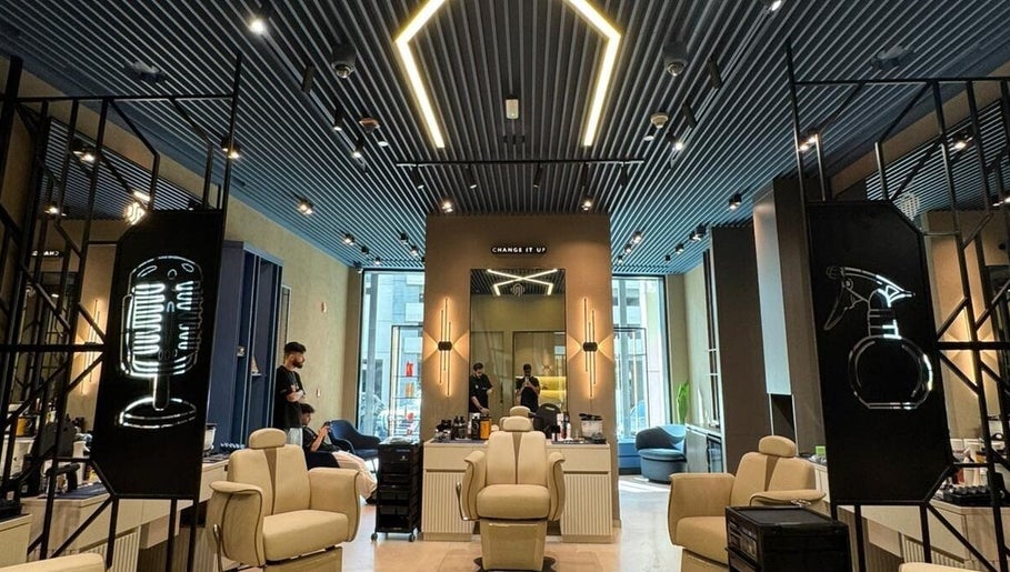 Interior of SHUFFLE Gents Salon Hessah District at Al Asimah Governate, showcasing stylish chairs and modern decor.