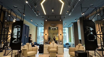 Interior of SHUFFLE Gents Salon Hessah District at Al Asimah Governate, showcasing stylish chairs and modern decor.