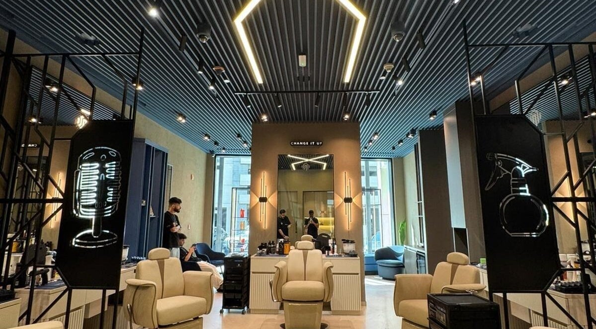 Interior of SHUFFLE Gents Salon Hessah District at Al Asimah Governate, showcasing stylish chairs and modern decor.