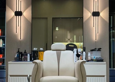 Elegant barber chair at SHUFFLE Gents Salon Hessah District, Al Asimah Governate, KW, beautifully lit interior.