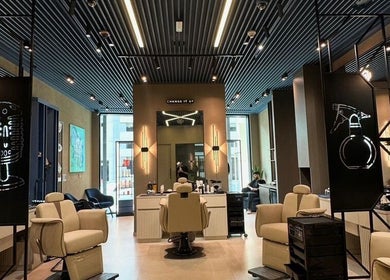 Modern interior of SHUFFLE Gents Salon Hessah District at Al Asimah Governate, KW featuring chic decor and stylish seating.