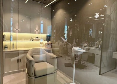 Luxurious interior of SHUFFLE Gents Salon Hessah District in Al Asimah Governate, KW shows a modern salon chair.