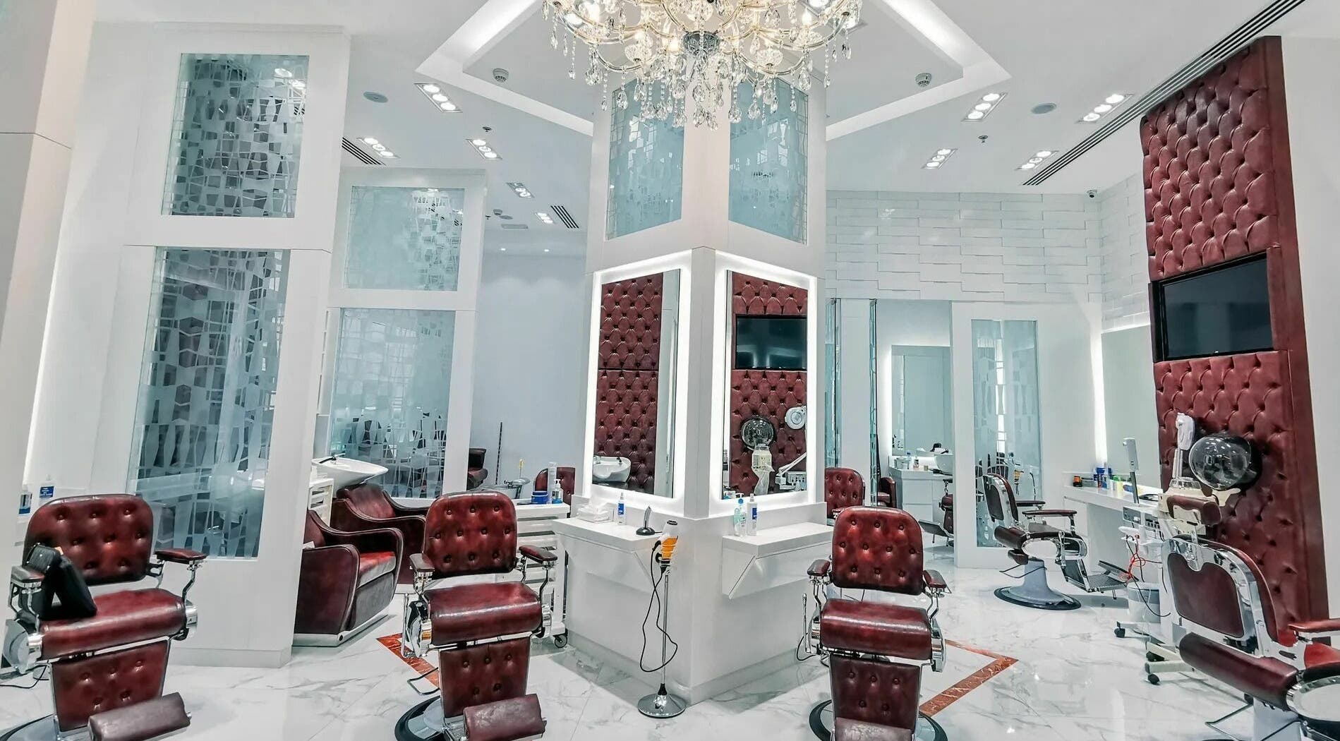Luxurious interior of Groomen Barbershop Circle Mall in Dubai, AE, featuring stylish chairs and elegant decor.