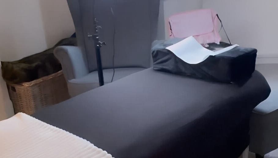 A relaxing treatment room at Lashes by Valeria in Birmingham, England, GB, featuring a cozy massage table.