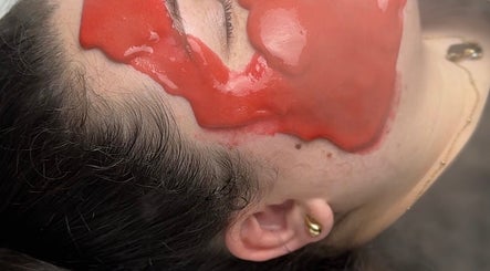 Relaxing facial treatment at Afterglow Beauty, Cambridge, England, GB, featuring a rejuvenating red mask.