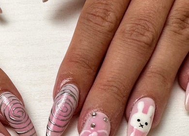 Creative nail art with pink swirls and embellishments at Afterglow Beauty, Cambridge, England, GB.