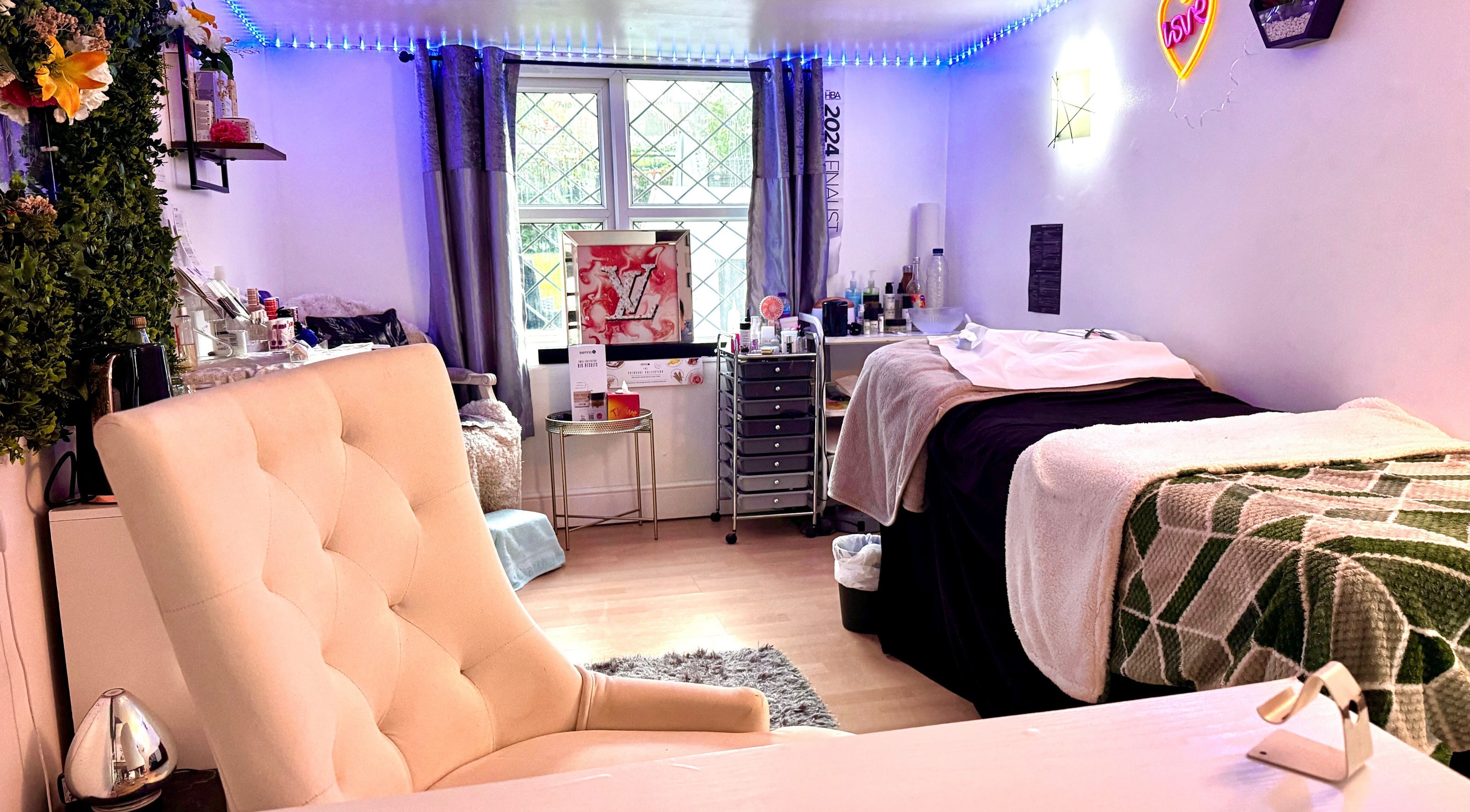 Cozy beauty room at Afterglow Beauty, Cambridge, England, GB with plush seating and treatment beds.