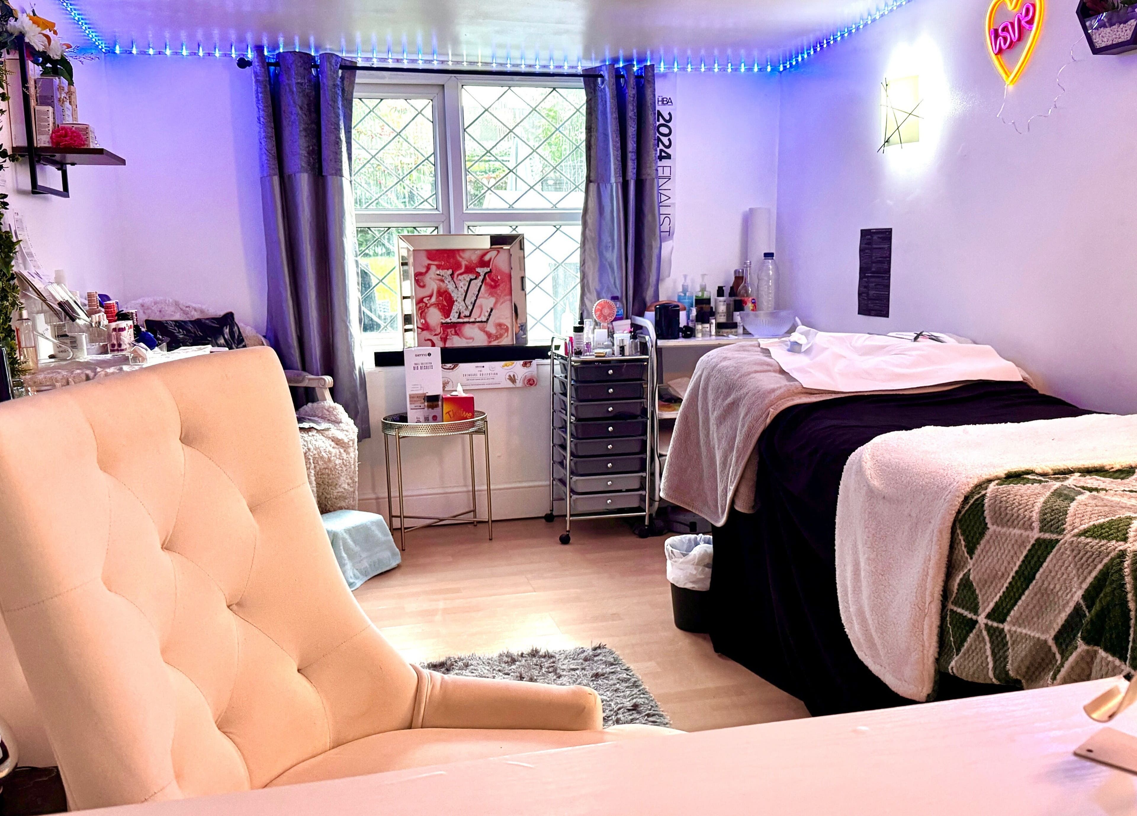 Comfortable beauty room setup at Afterglow Beauty in Cambridge, England, GB featuring cozy seating and soft lighting.