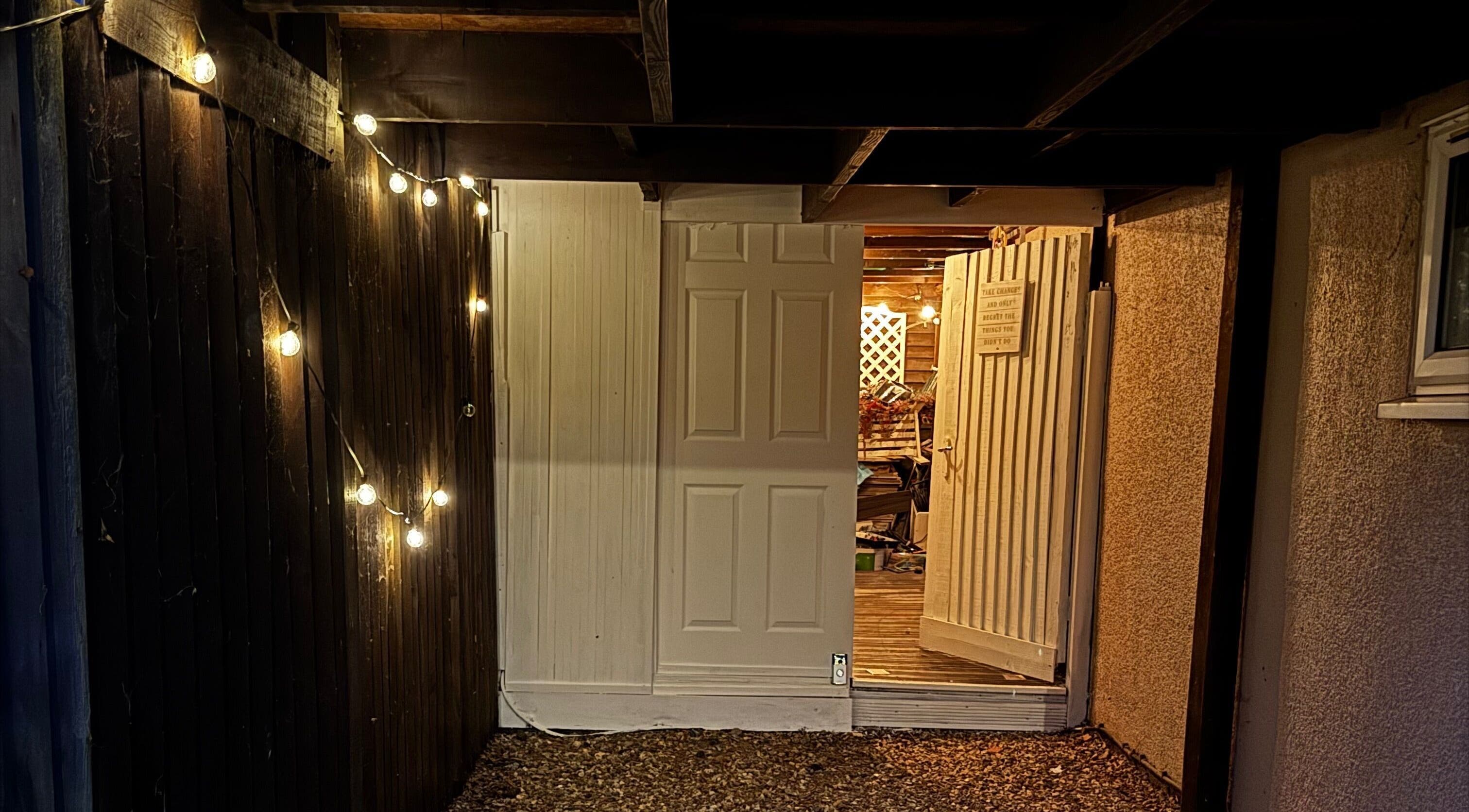 Entrance to Afterglow Beauty in Cambridge, England, GB with warm string lights.