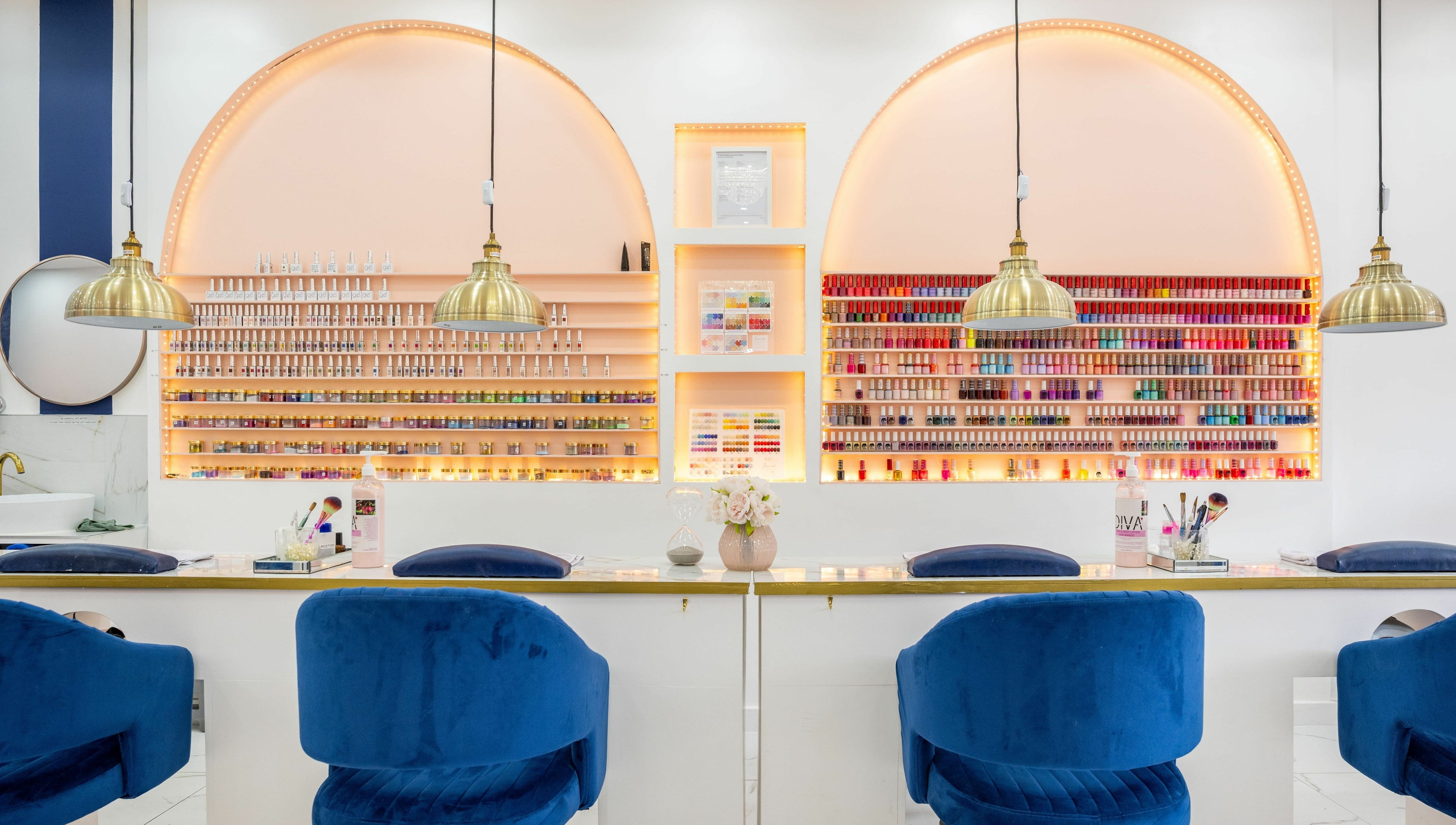 Vanity Nail Bar in Brierley Hill, England showcases a chic manicure setup with vibrant polish on lit shelves.