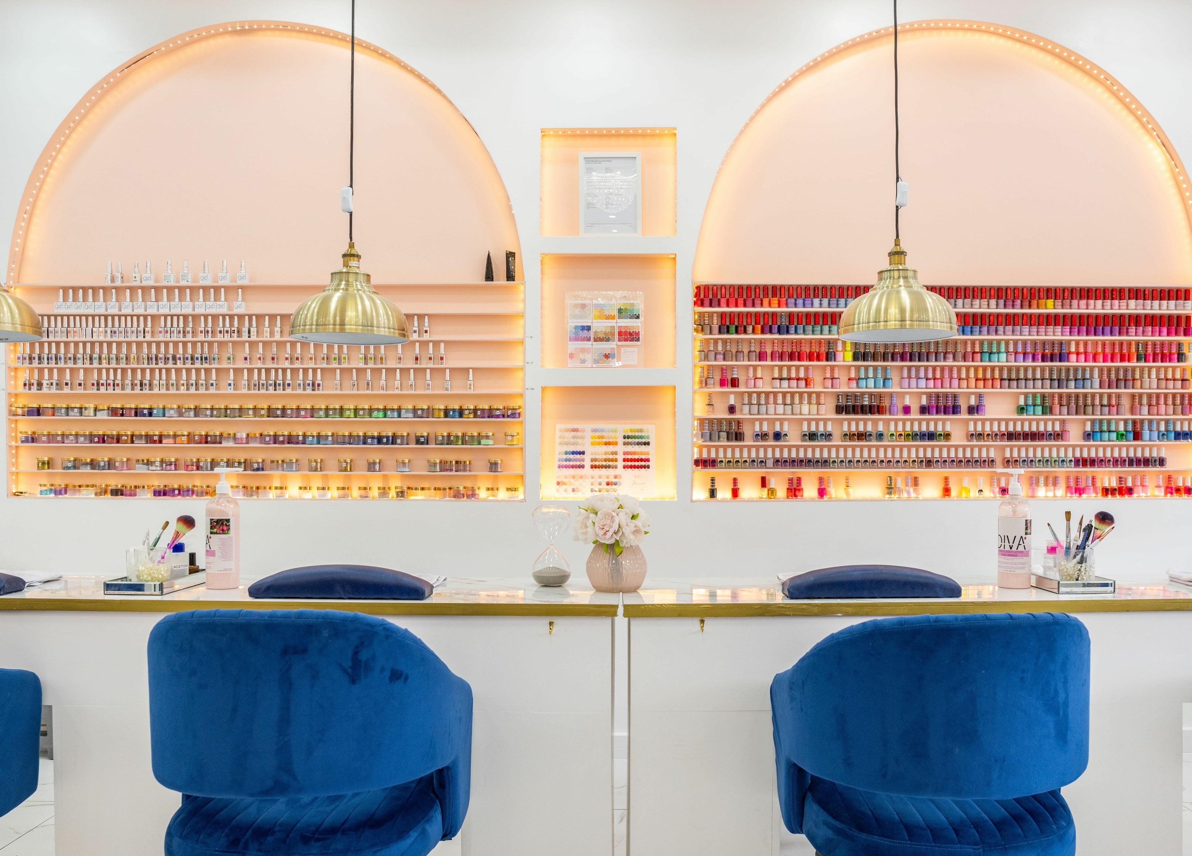 Vanity Nail Bar in Brierley Hill, England showcases a chic manicure setup with vibrant polish on lit shelves.