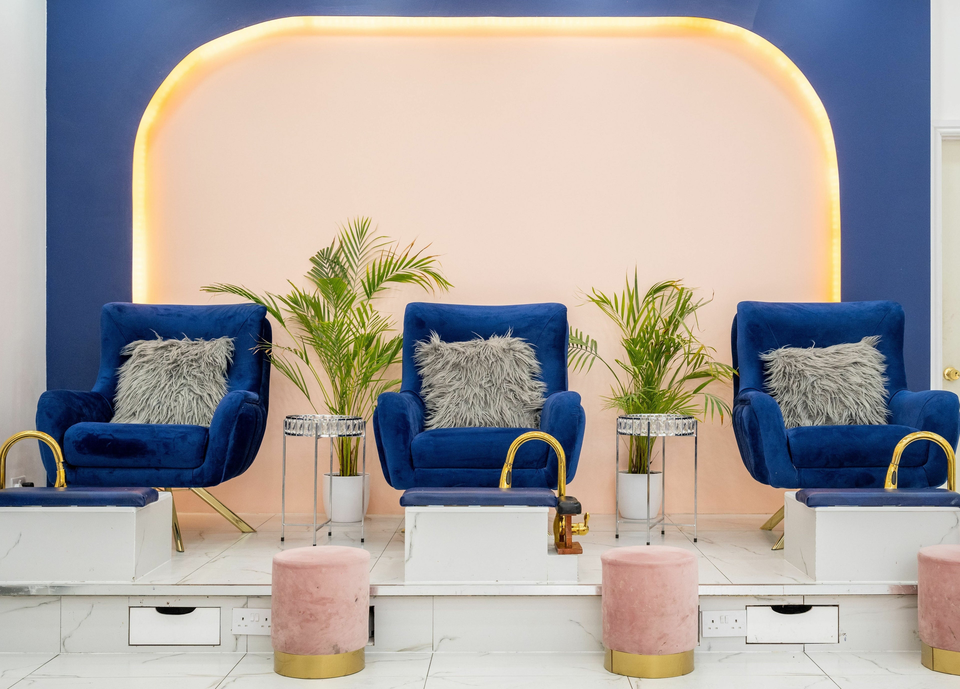 Elegant pedicure chairs at Vanity Nail Bar, Brierley Hill, England, GB, with plush seating and lush plants.