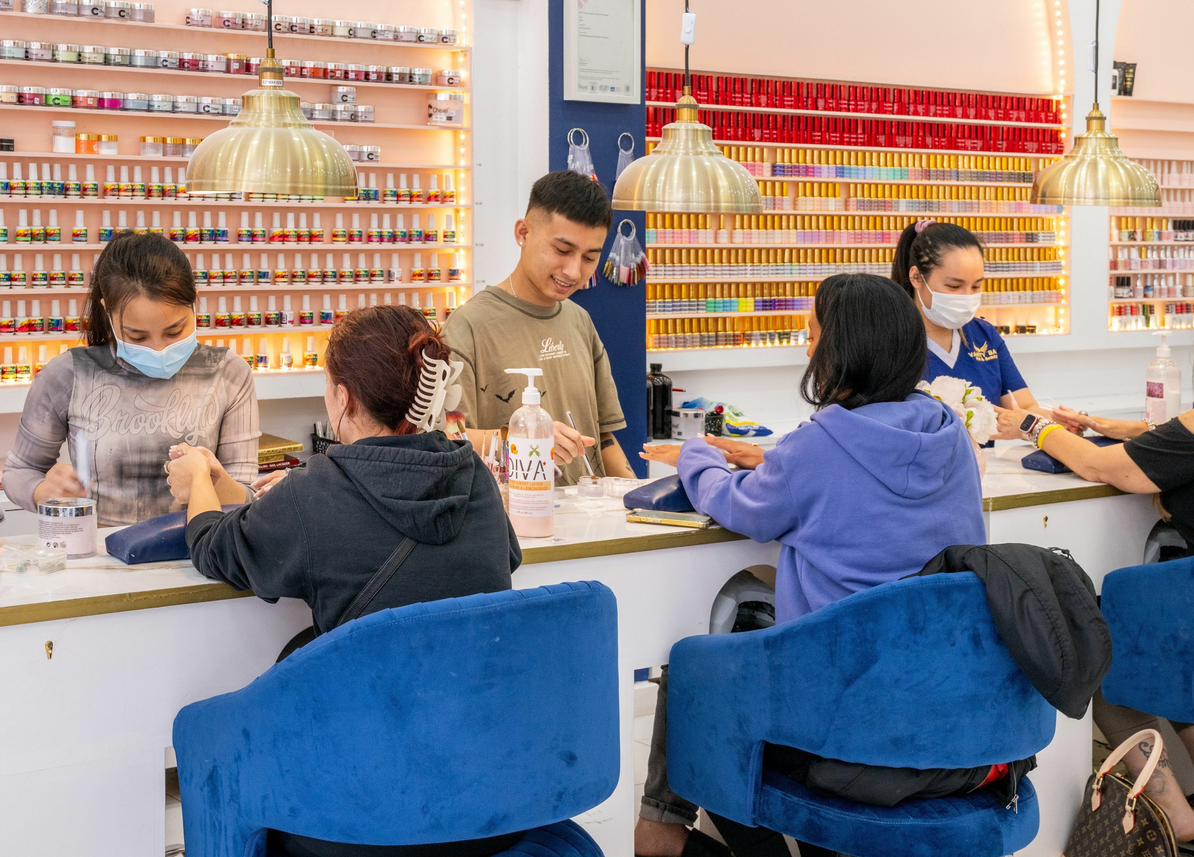 Customers enjoying nail services at Vanity Nail Bar, Brierley Hill, England, GB, with vibrant polish displays.