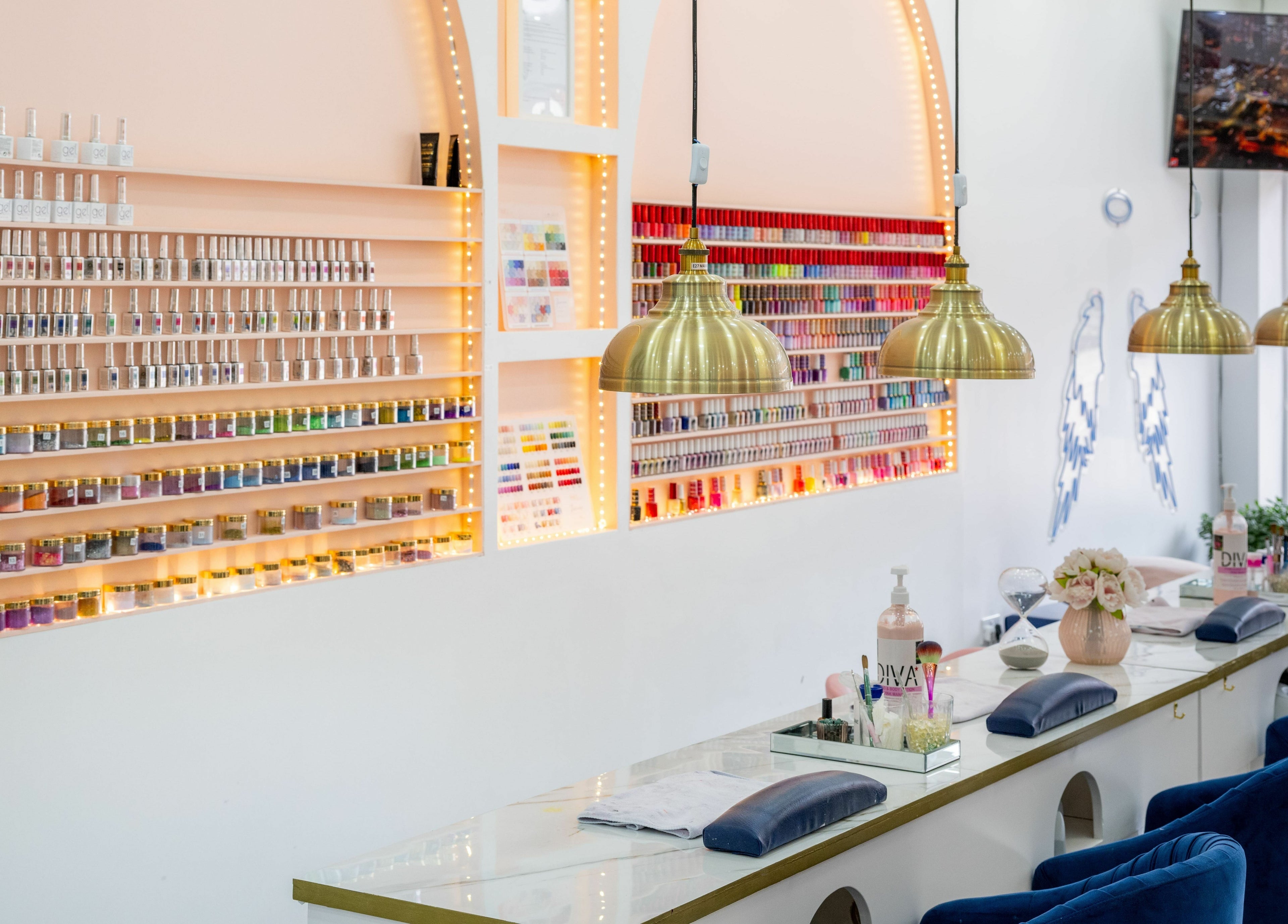 Elegant interior of Vanity Nail Bar, Brierley Hill, England, showcasing stylish seating and vibrant polish displays.