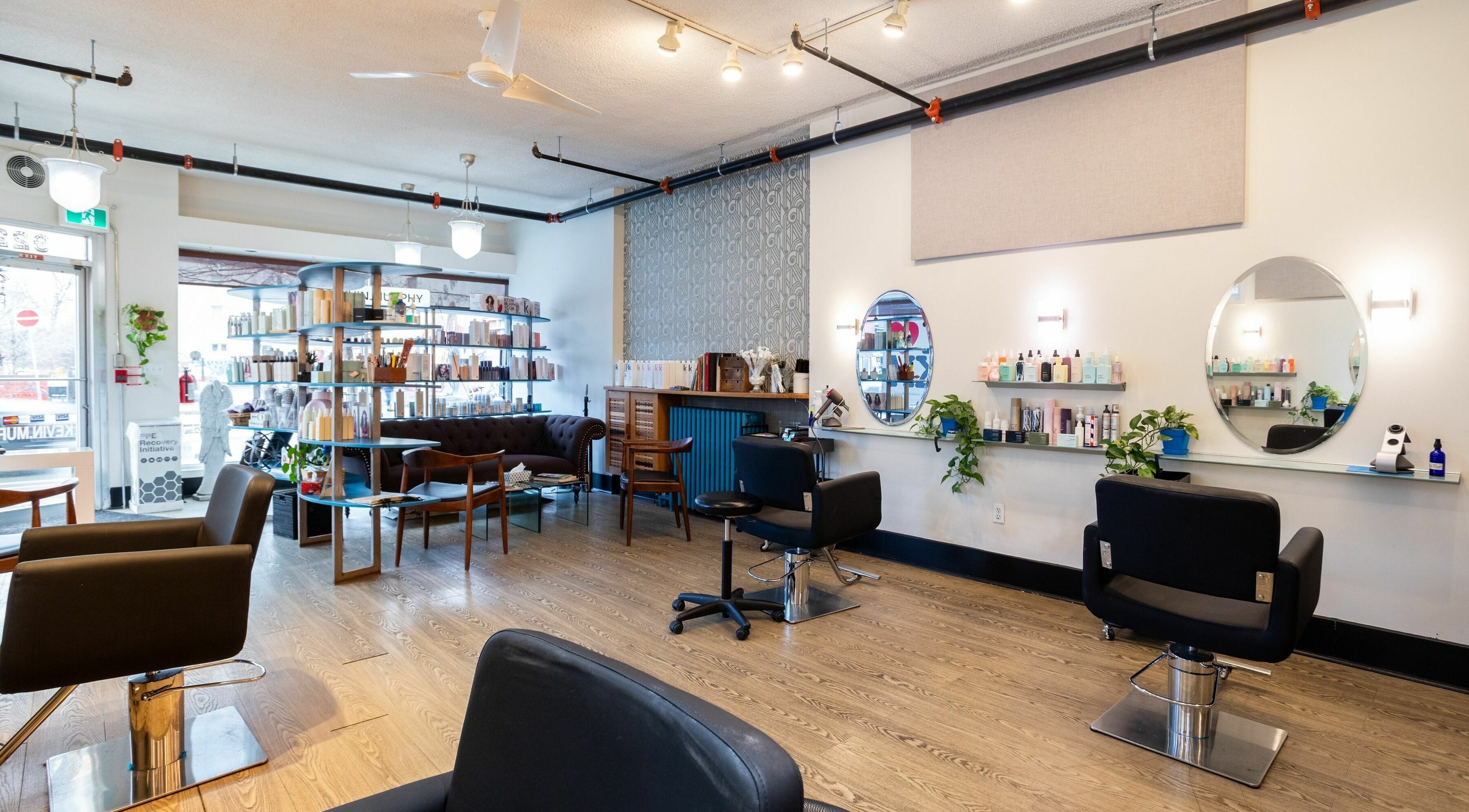 Modern interior of Angel Hair Salon in Toronto, Ontario, CA, featuring stylish chairs and beauty products.
