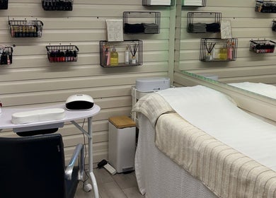 O J Beauty's tranquil treatment area in Gravesend, England, GB featuring a cozy bed and nail station.