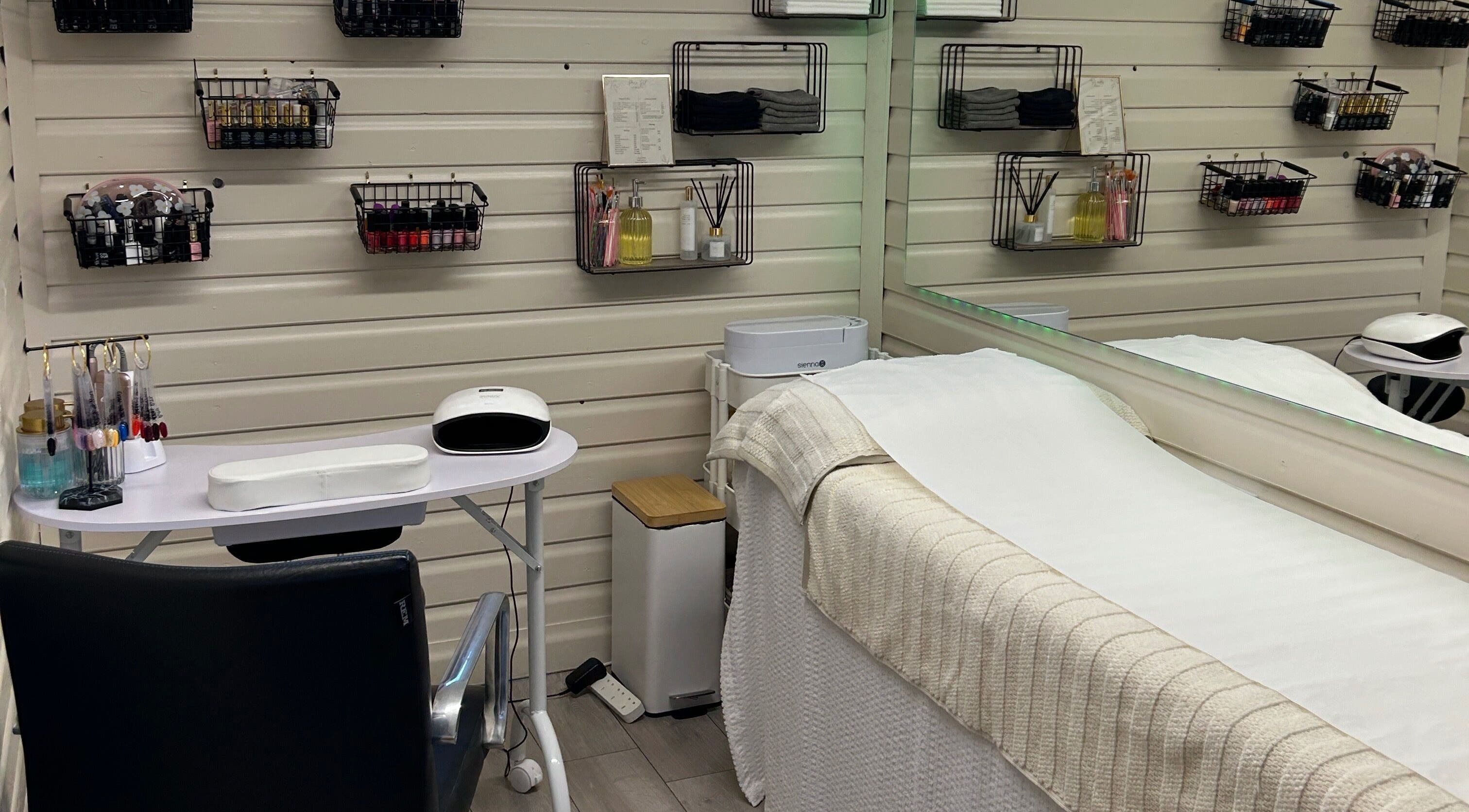 O J Beauty's tranquil treatment area in Gravesend, England, GB featuring a cozy bed and nail station.