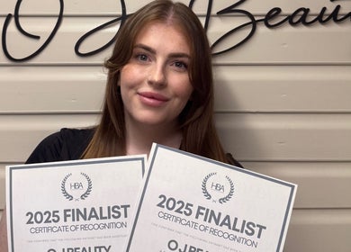 Award winner holding certificates at O J Beauty, Gravesend, England, GB.