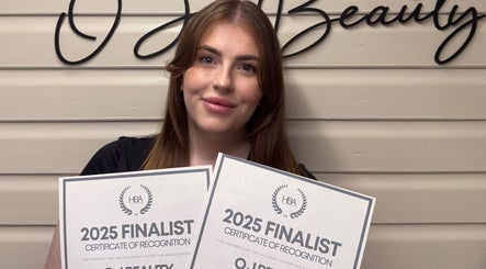 Award winner holding certificates at O J Beauty, Gravesend, England, GB.